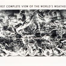 A black and white aerial image of swirling patterns of clouds and weather over the surface of the earth.