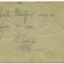 The back of a weathered envelope that has the words "hello newport / regards from a son" and George Schnitzer's signature written on it.