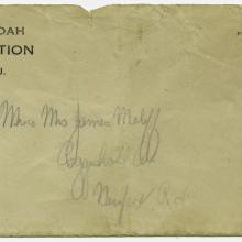 A weathered addressed envelope with a stamp in the upper righthand corner and the words USS Shenandoah, Naval Air Station, Lakehurst, N.J. in the upper lefthand corner.