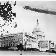 A photo of the USS Shenandoah flying over the Capitol dome.