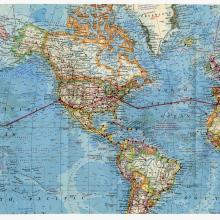 A map of the world with a flight path that travels from one end to the other.