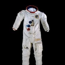 A spacesuit pictured against a black backdrop.