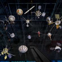 Set of 15 satellites of different shapes and sizes hanging from the ceiling