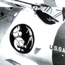 Insignia on the side of a aircraft that shows two people during a trapeze act.