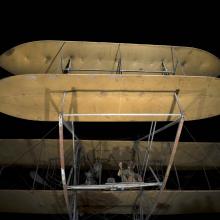 A closeup of a vintage airplane's elevators on a black background.