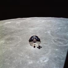 A silver cylindrical module with a cone-shaped lid floats above the Moon.