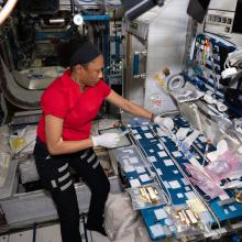 A woman gloating in zero gravity while inside the International Space Station.