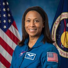 Official NASA portrait of Jeanette Epps wearing a blue astronaut flight suit.