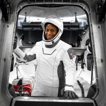 Astronaut Jeanette Epps wearing SpaceX suit while inside a space capsule.