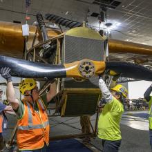 Contractors removing propeller from a plane