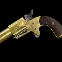 Side view of a yellow painted flare pistol.