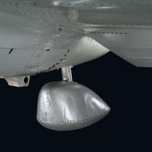 Round bulb-shaped metal rear landing ski on bottom of Northrop Gamma Polar Star aircraft