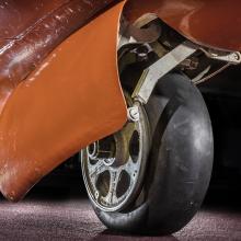 View of a tire on an aircraft. The aircraft is painted orange. 