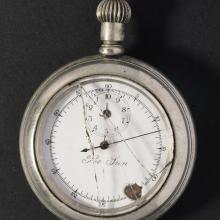 Broken stopwatch with hand pointed at nine-minute mark. 