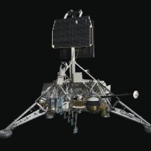 View of a spacecraft with solar panels and a gas tank.