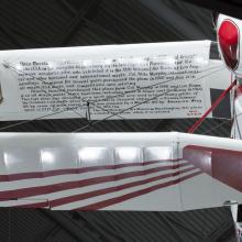 White and red painted wing with black text. 