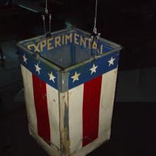 Red, white and blue metal balloon basket flown at a centennial commemoration of John Wise's Jupiter balloon flight