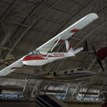 Red and white plane hanging in the museum. N2790Z is painted on the side of the plane.