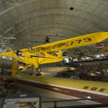 Yellow biplane hanging in the museum.