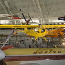 Yellow painted bi-plane hanging in the museum. 