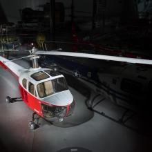 View of a red and white helicopter inside of the museum. 