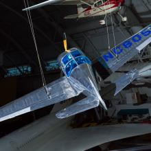 Top rear view of a metal plane hanging in the museum. 