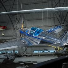 Rear view of a silver painted plane hanging in the museum. 