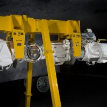 Robotic arm attached to a support beam. 