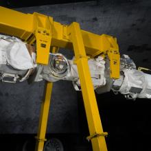 Robotic arm attached to a support beam. 