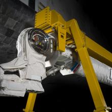  Robotic arm attached to a support beam. 