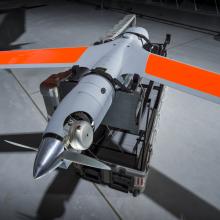 Wings of a grey and orange unmanned aircraft 