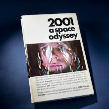 A book titled 2001 A Space Odyssey with a human face on the cover. 