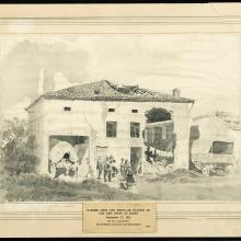 Damaged building with soldiers standing outside. 