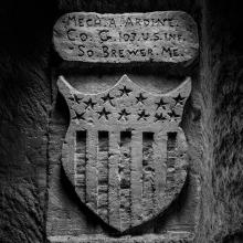 Engraving in stone of stars and stripe emblem. 