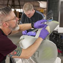 Bill George marks windows on the secondary hull of the Enterprise model. 