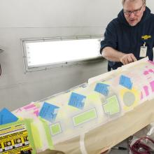 Post-it notes and masking tape create an outline on the model's secondary hull. 