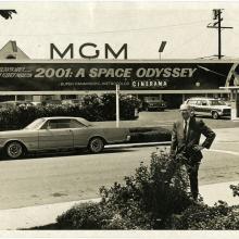 Arthur C. Clarke poses for a photo beneath a sign advertising the motion picture "2001: A Space Odyssey," May 16, 1968.