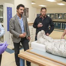 A group of backers of a Kickstarter campaign to restore the spacesuits of Neil Armstrong and Alan Shepard receive a behind the scenes look at Armstrong's spacesuit with a Museum curator (left) as a Kickstarter benefit.