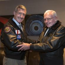 NASA Astronaut and Coast Guard Captain Eugene "Daniel" Burbank stands left of General Jack Dailey, a former Museum Director, on the night of an annual museum lecture.