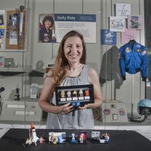 Maia Weinstock with her LEGO® set in front of a Sally Ride display case at the Smithsonian’s National Air and Space Museum in Washington DC.