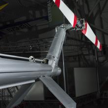 View of a red and white painted tail rotor on a helicopter.