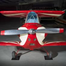 Nose of a red and white painted smallest man-carrying plane.