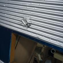 Close up of a window looking into the passenger cabin on a plane. 