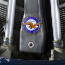 Close up view of a Pratt & Whitney logo on a propeller attached to an engine of a plane.