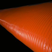 Close up image of an orange wing and light of a plane.