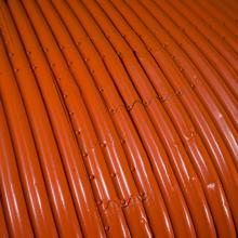 Close up image of an orange wing of a plane.