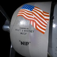 View of an engine with an American flag logo on an airplane. 