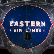 Close up of the nose of the plane. Painted on a blue nose is the phrase "Eastern *Air Lines."