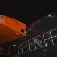 Orange wings and black painted fuselage of an airplane.