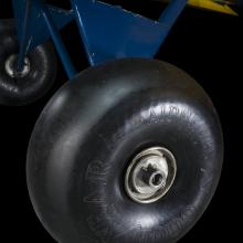 Close of of a tire and blue painted landing gear of a airplane. 